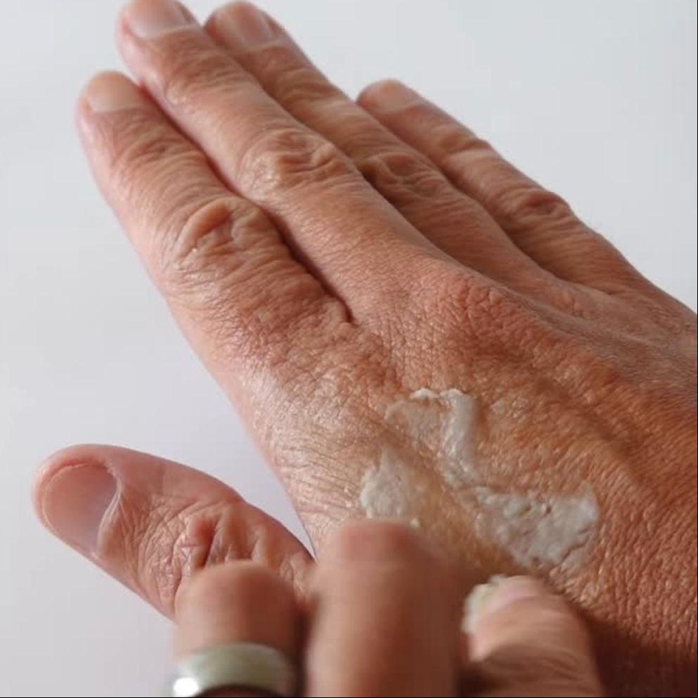 Hand Applying Leaf Skincare Salve Onto Skin